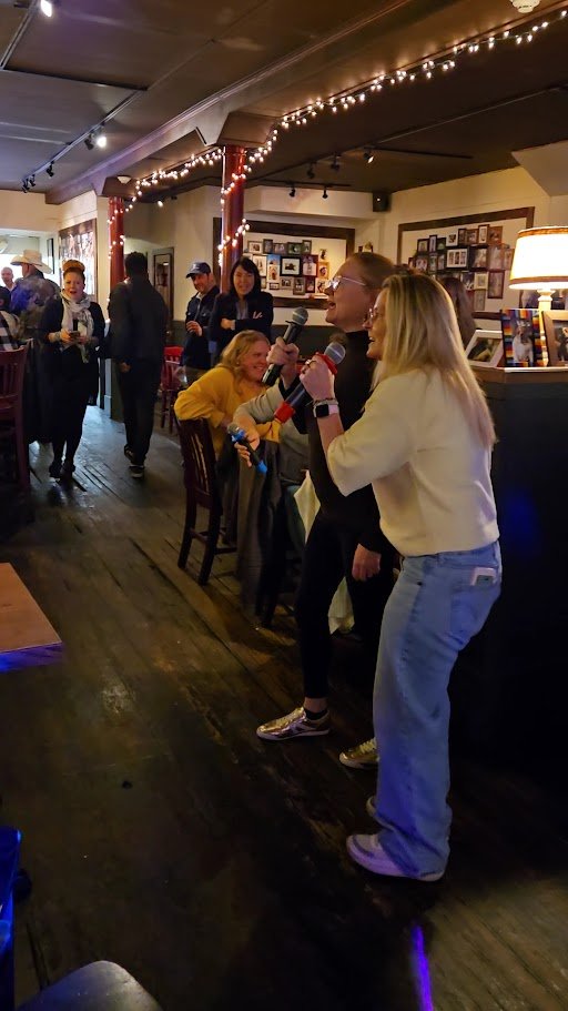 American pub tables beneath playful dog photos.
